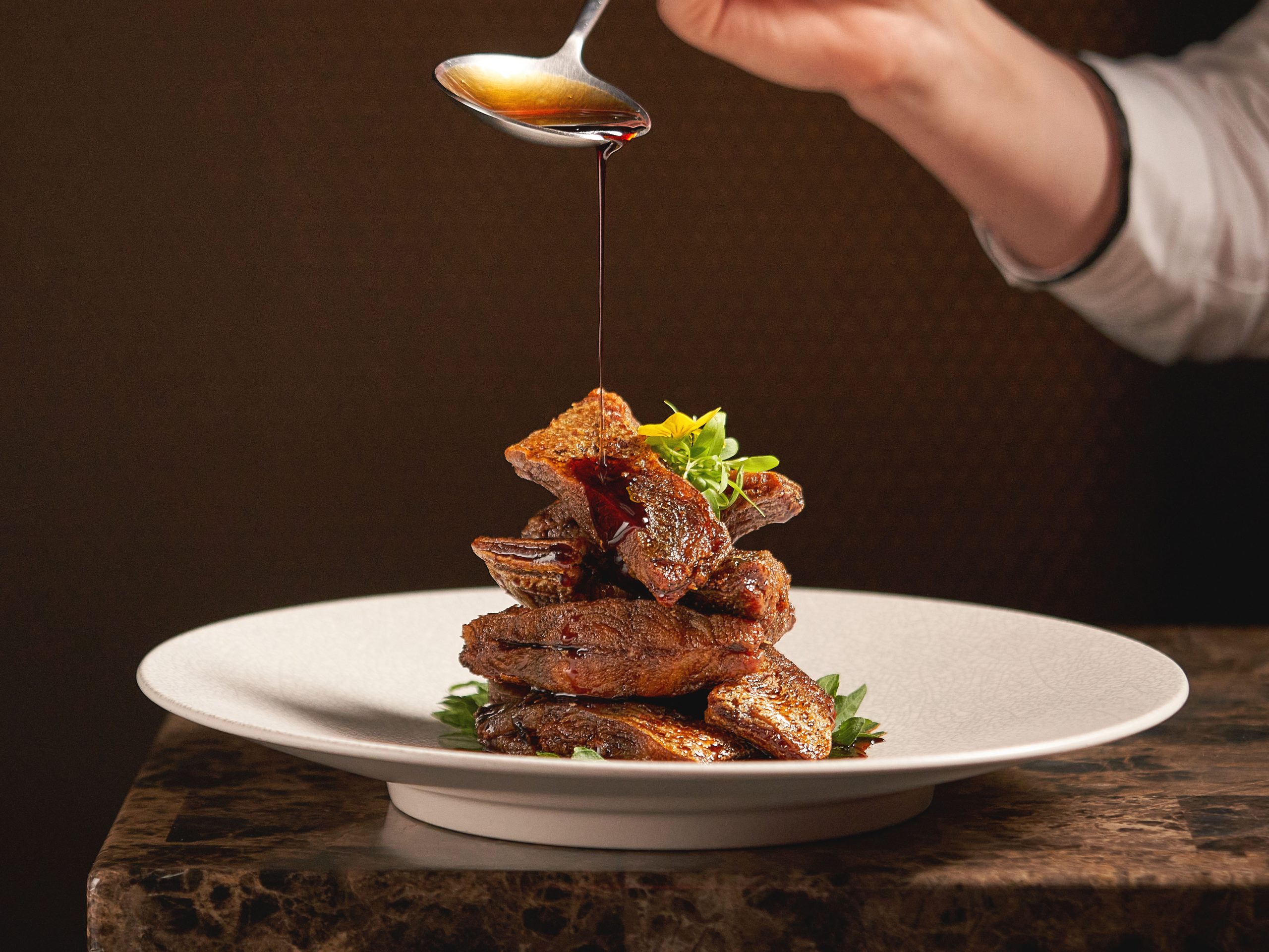 上海本帮经典前菜 - 秘制熏鲳鱼，外酥里嫩，淋有特色酱汁。